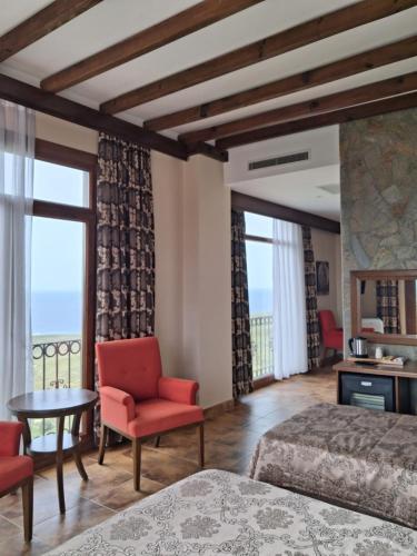 a hotel room with two beds and a table and chairs at Masi Otel in Bademli