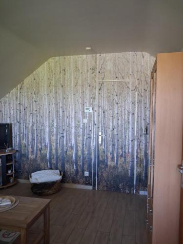 a room with a mural of aspen trees at A l'orée du Bois in Landelies