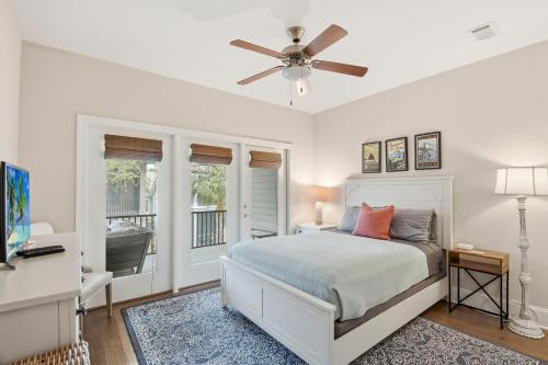 a bedroom with a bed and a ceiling fan at Garden Cottage 62 in Jekyll Island