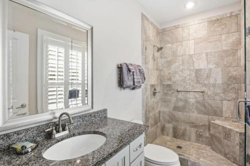 a bathroom with a sink and a shower at Garden Cottage 62 in Jekyll Island