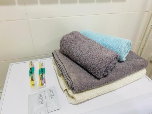 two towels and toothbrushes on a counter in a bathroom at Comfort Home Gogolya in Karagandy
