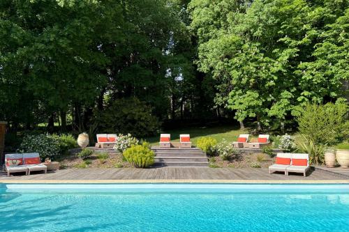 a group of chairs and a swimming pool at La Maison 1680 in Couches