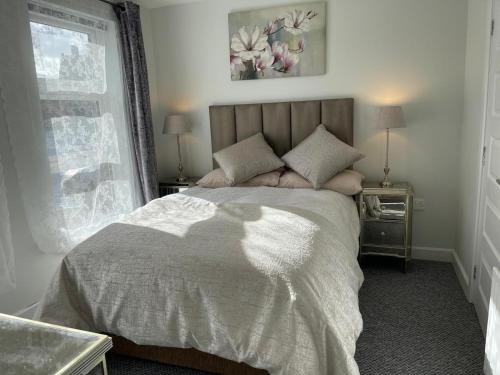 a bedroom with a large bed and a window at Old Schoolhouse Coleraine in Coleraine