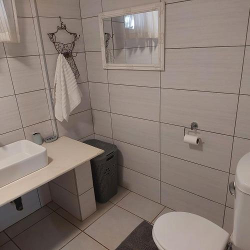 a bathroom with a toilet and a sink at 1atKruger Unit 2 in Mokopane