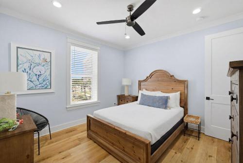 a bedroom with a bed and a ceiling fan at The Perch in Gulf Shores