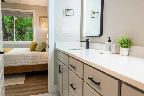 a bathroom with a sink and a mirror at Cliffside Modern Villa. Secluded and accessible. in Asheville