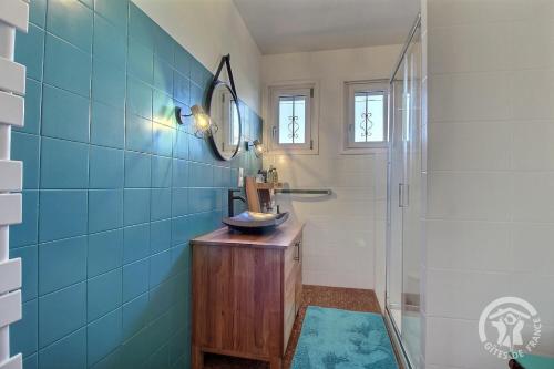 a bathroom with a sink and a mirror and a shower at Maison d'hôtes de kervor in Plouézec