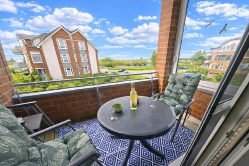 a balcony with a table and chairs and a window at de Bark in Dorum-Neufeld