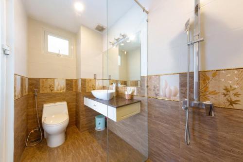 a bathroom with a toilet and a sink and a shower at Michael Hotel in Nha Trang