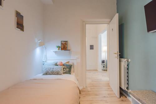 a small room with a bed and a hallway at Le Case di Sonia Maison Mami' in Fucecchio