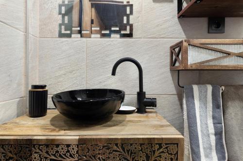 a bathroom with a black sink and a faucet at Beach fun in Costa da Caparica