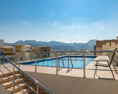 a swimming pool on the roof of a building at Royal Crown Muscat in Muscat