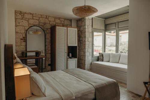 a bedroom with a bed and a couch at Alaçatı Lotus Bahçe in Alaçatı