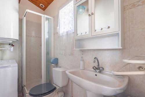 a bathroom with a sink and a toilet and a shower at Location Oléron centre La Cotinière in Saint-Pierre-dʼOléron