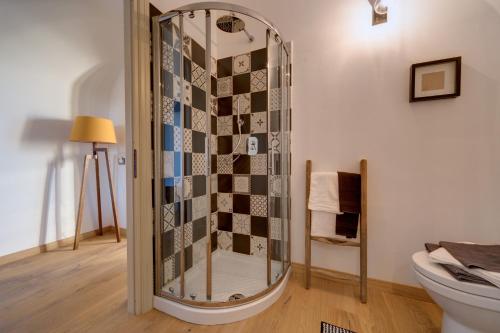 a glass shower in a bathroom with a toilet at Podere Demetra in Novi Ligure