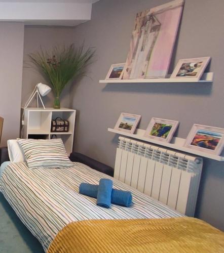 a bedroom with a bed with pictures on the wall at El Mirador de Murillo in Murillo de Río Leza