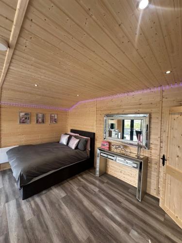 a bedroom with a bed in a wooden room at CASSA Sophia in Ballygowan
