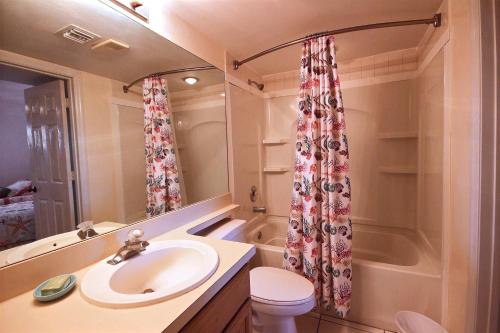 a bathroom with a sink and a toilet and a tub at 2306 Ocean Pointe Suites in Tavernier