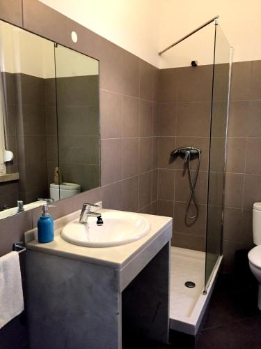 a bathroom with a sink and a shower at Lisbonera Guest House in Lisbon