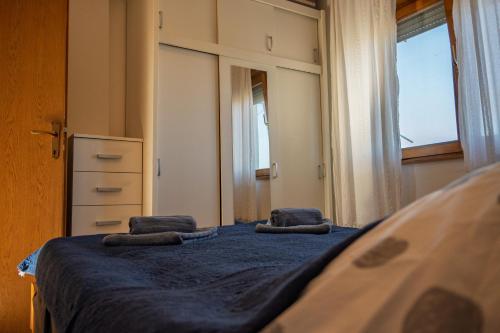 a bedroom with a bed with two pillows on it at Apartman Jedro in Vukovar