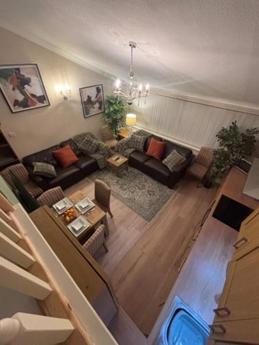 a living room with a couch and a table at Hollybrake Haven Gatwick in Crawley