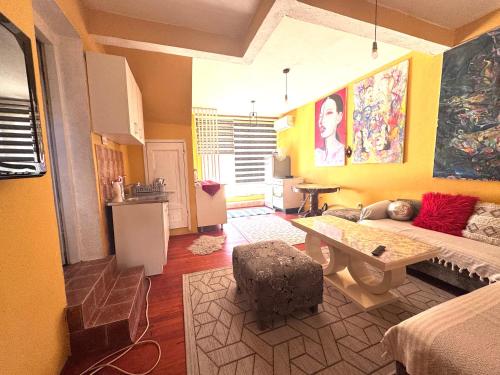a living room with a couch and a table at MM Apartman in Foča