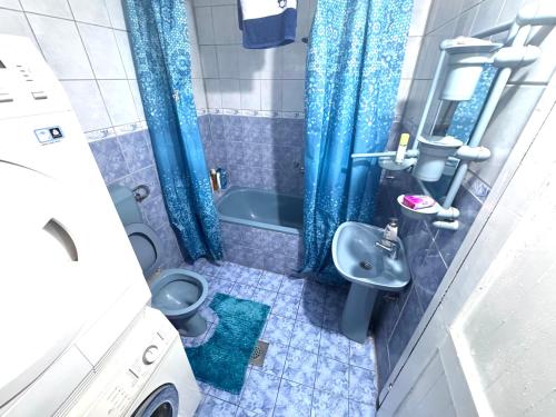 a small bathroom with a toilet and a sink at MM Apartman in Foča