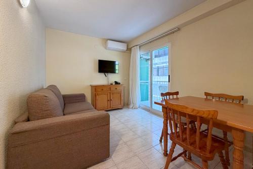a living room with a couch and a dining room table at Climia 2Sleep Apartments in Benidorm
