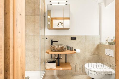 a bathroom with a sink and a shower at Ferienwohnung Antretter **** in Neubeuern
