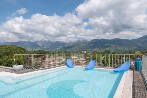 a swimming pool with a view of mountains at Residence Verdeluna in Marina di Pietrasanta