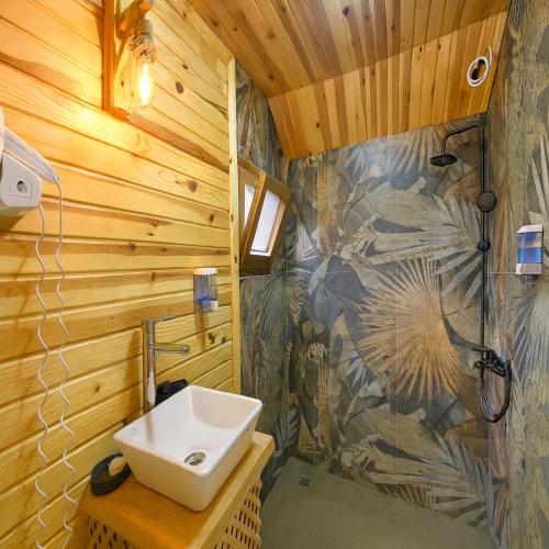 a bathroom with a sink and a shower at White Country Villages Hotel in Antalya