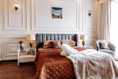a bedroom with a large bed with a gray headboard at Summer Villa in Lahore