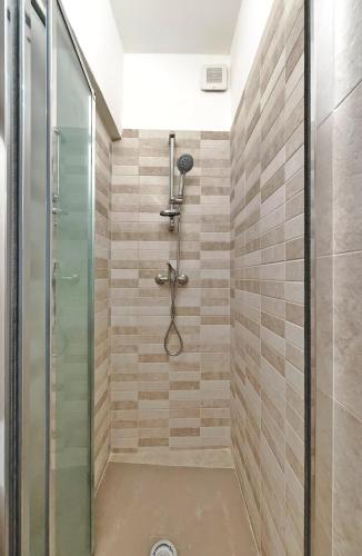 a bathroom with a shower with a glass door at Zio Achille in Gallipoli