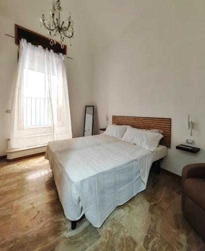 a bedroom with a large bed and a window at Zio Achille in Gallipoli