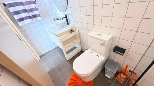 a small bathroom with a toilet and a sink at Fantasea Condo Kamala 1bdr in Kamala Beach