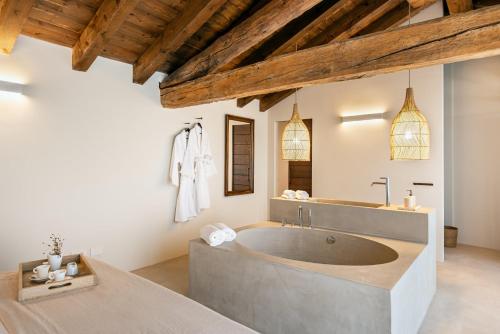 a large bathroom with a large tub in a room at Suite della Torre in Cavernago