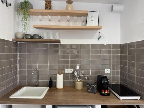 a kitchen with a sink and a counter with glasses at LaJoya Zuheros Suite in Zuheros