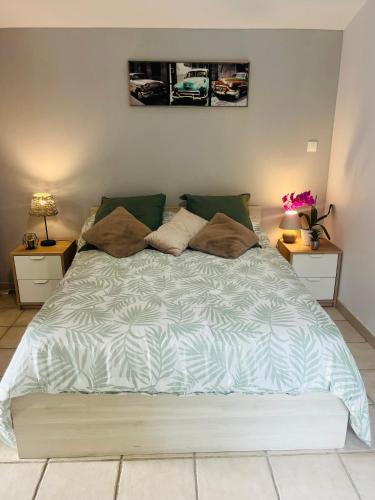 a large bed in a bedroom with two night stands at Caza Bodo in Sausset-les-Pins