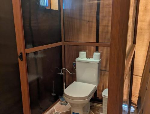 a small bathroom with a toilet and a shower at Grand Dunes Luxury Camp in Merzouga