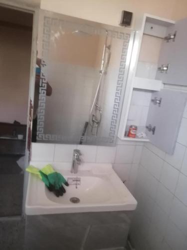 a bathroom sink with a green towel on it at iomnium in Tigzirt