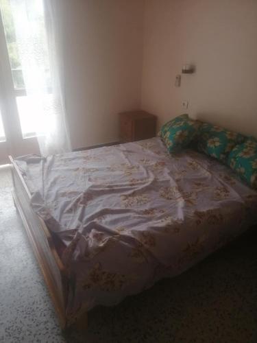 a bedroom with a large bed with a sheet on it at iomnium in Tigzirt