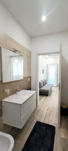 a bathroom with a large white tub and a sink at Chez Romeo in Ravenna