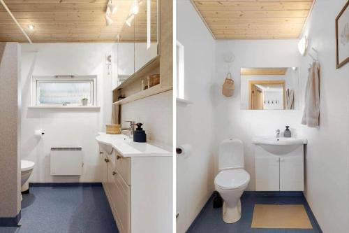 a white bathroom with a toilet and a sink at OH585-Hadsund-Brondbaekken-34 in Øster Hurup