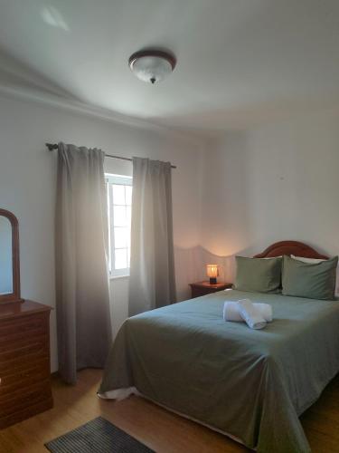 a bedroom with a bed with a mirror and a window at Alojamento Local Velas Balcony in Velas