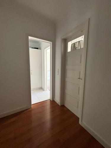 an empty room with a door and a window at The room in Odivelas