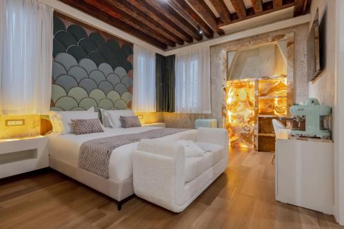 a bedroom with a white bed and a chair at Ares Venice Bed & Relais in Venice