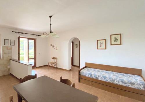 a bedroom with a bed and a table and chairs at Residence Antonella in Capoliveri