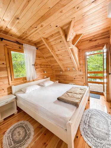a bedroom with a bed in a log cabin at Chalet Aleksa in Žabljak