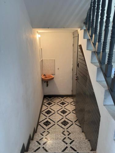 a hallway with a staircase and a table on a tiled floor at Coco villa in Flic-en-Flac