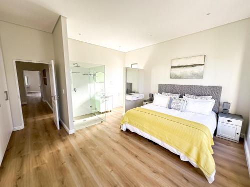 a bedroom with a bed and a glass shower at Bluebay Villa in Britannia Bay